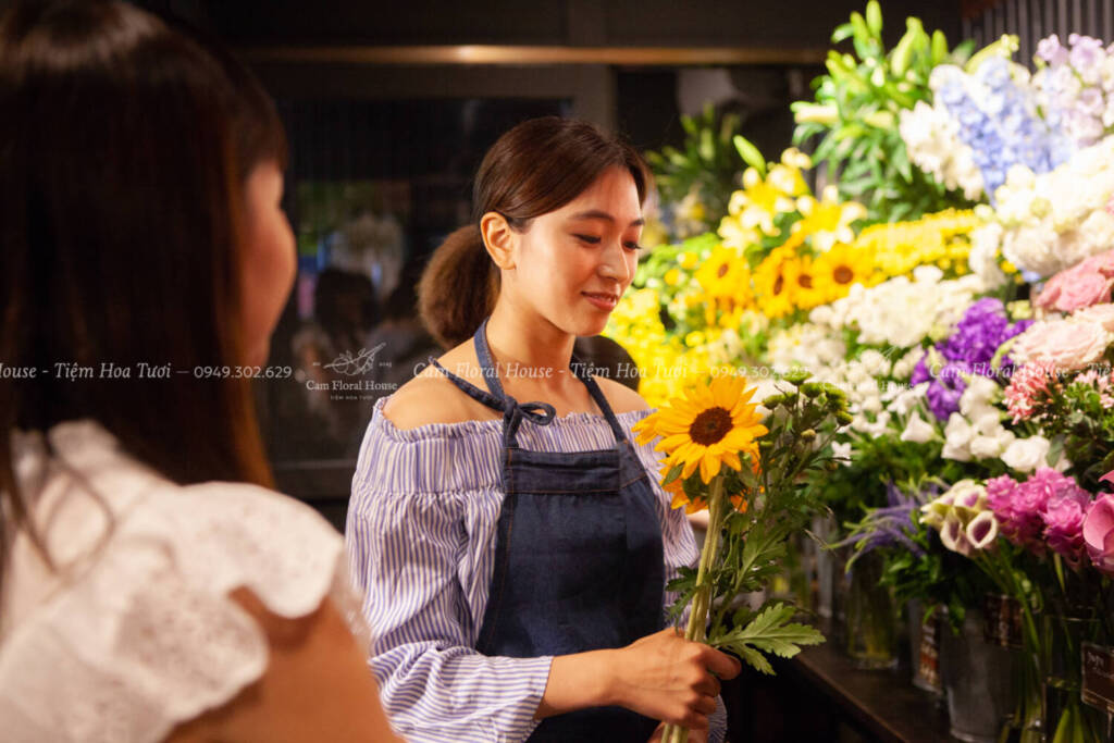 A florist clerk and a young guest.